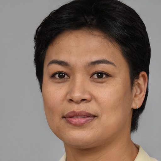 Joyful asian young-adult female with short  brown hair and brown eyes