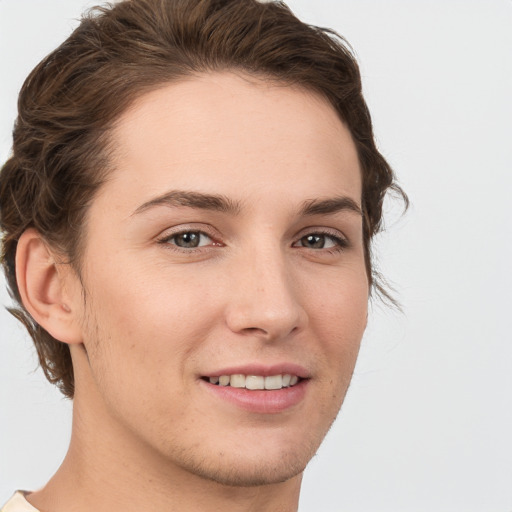 Joyful white young-adult female with short  brown hair and grey eyes