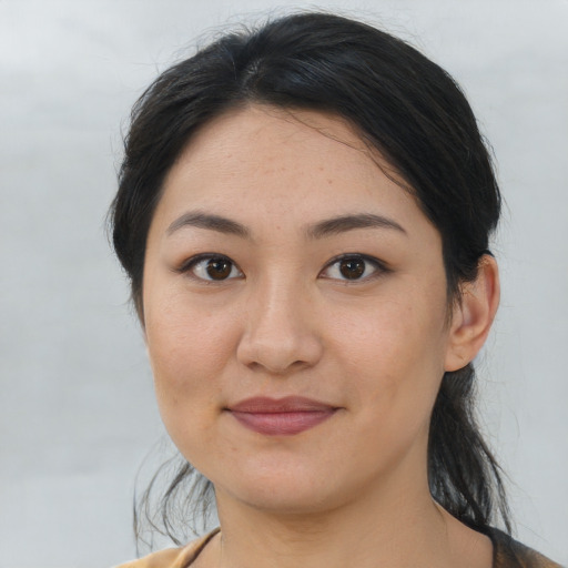 Joyful asian young-adult female with medium  brown hair and brown eyes