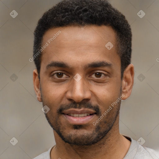 Joyful black young-adult male with short  black hair and brown eyes