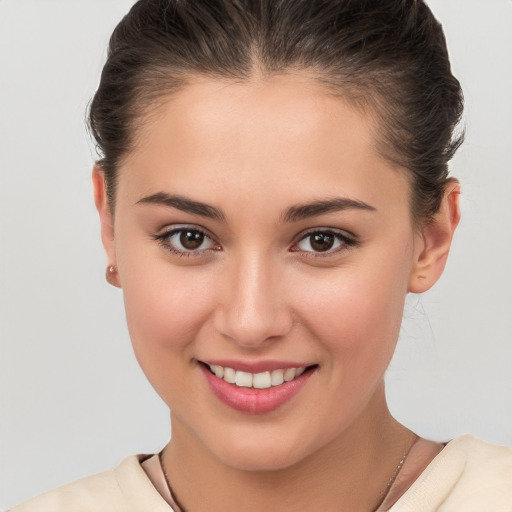 Joyful white young-adult female with medium  brown hair and brown eyes