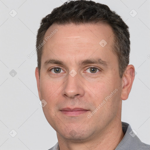 Joyful white adult male with short  brown hair and brown eyes