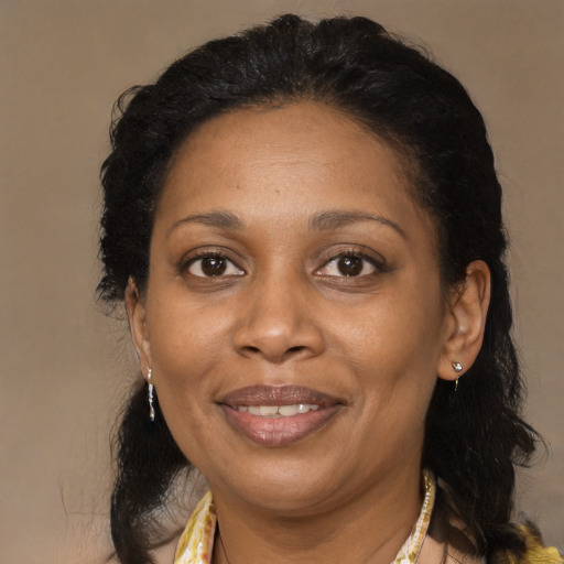Joyful black adult female with medium  brown hair and brown eyes