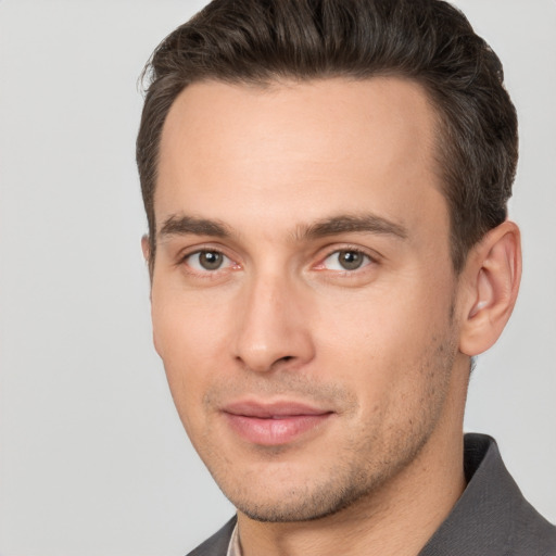 Joyful white young-adult male with short  brown hair and brown eyes