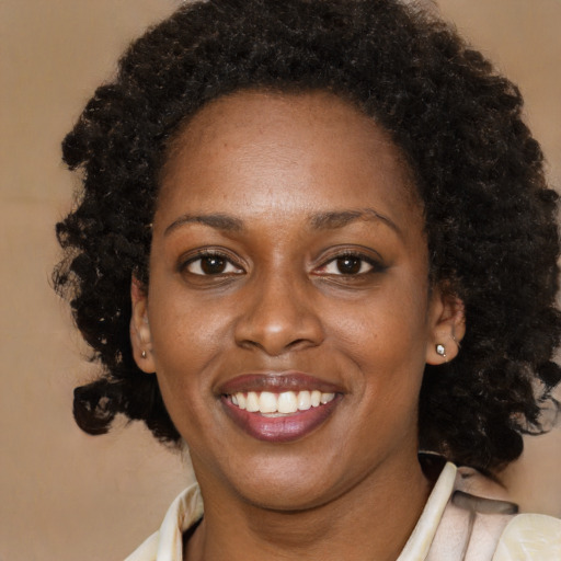 Joyful black young-adult female with medium  brown hair and brown eyes