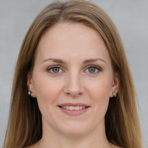 Joyful white young-adult female with long  brown hair and blue eyes