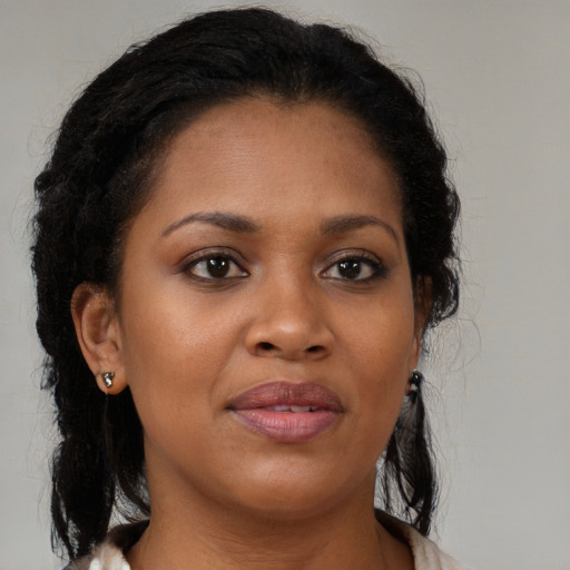 Joyful black young-adult female with medium  brown hair and brown eyes