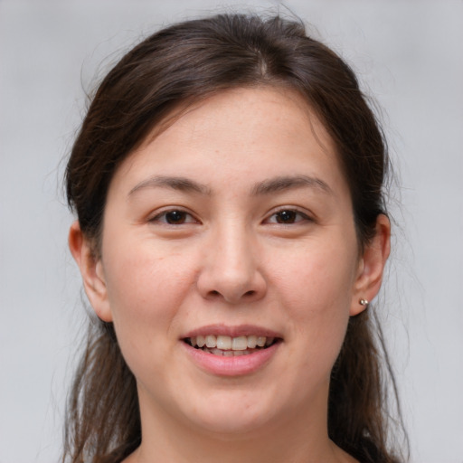 Joyful white young-adult female with medium  brown hair and brown eyes