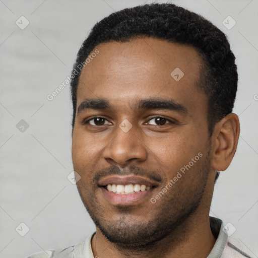 Joyful black young-adult male with short  black hair and brown eyes