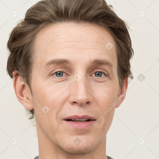 Joyful white adult male with short  brown hair and grey eyes