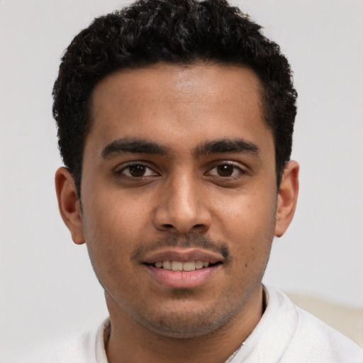 Joyful latino young-adult male with short  brown hair and brown eyes