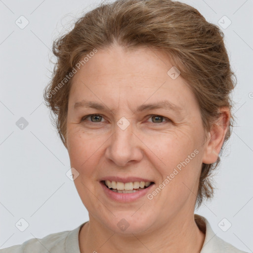 Joyful white adult female with short  brown hair and brown eyes