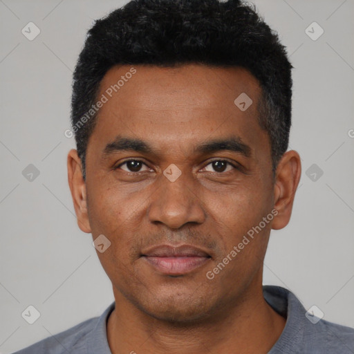 Joyful black young-adult male with short  black hair and brown eyes