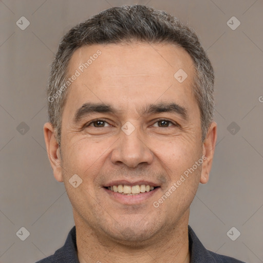 Joyful white adult male with short  brown hair and brown eyes