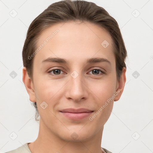 Joyful white young-adult female with short  brown hair and grey eyes