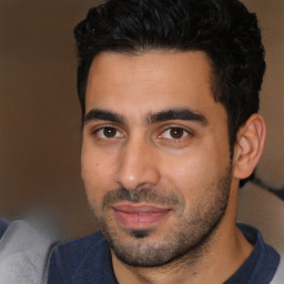 Joyful white young-adult male with short  black hair and brown eyes