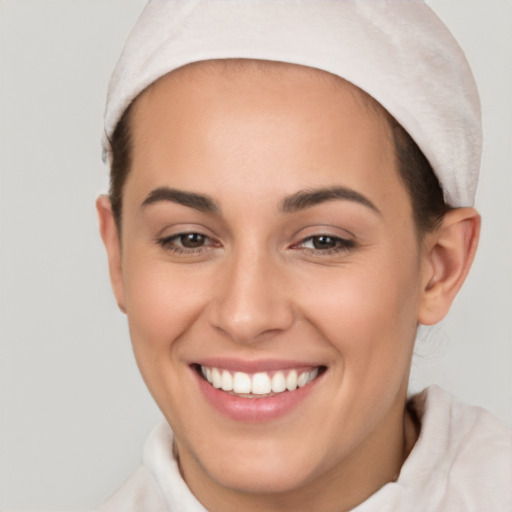 Joyful white young-adult female with short  brown hair and brown eyes