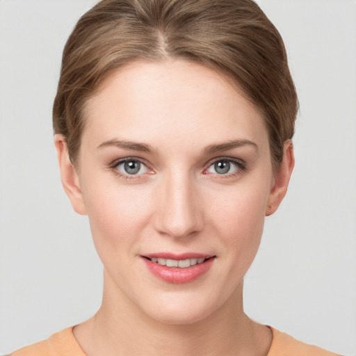 Joyful white young-adult female with short  brown hair and grey eyes