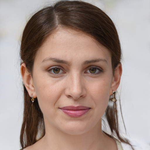 Joyful white young-adult female with medium  brown hair and grey eyes