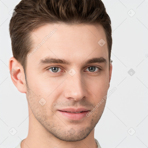 Joyful white young-adult male with short  brown hair and grey eyes