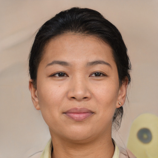 Joyful asian young-adult female with medium  brown hair and brown eyes