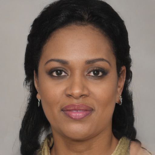 Joyful black young-adult female with medium  brown hair and brown eyes