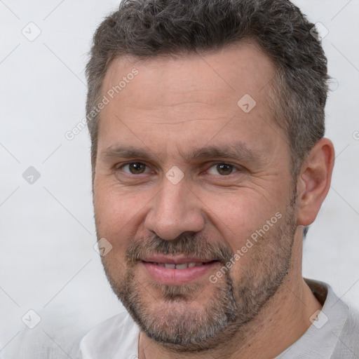 Joyful white adult male with short  brown hair and brown eyes