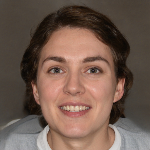 Joyful white adult female with medium  brown hair and blue eyes