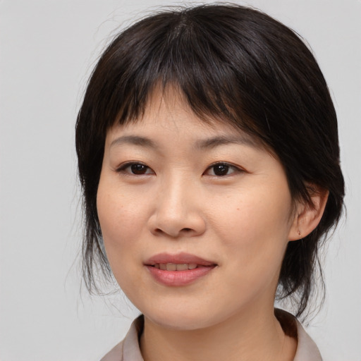 Joyful asian young-adult female with medium  brown hair and brown eyes