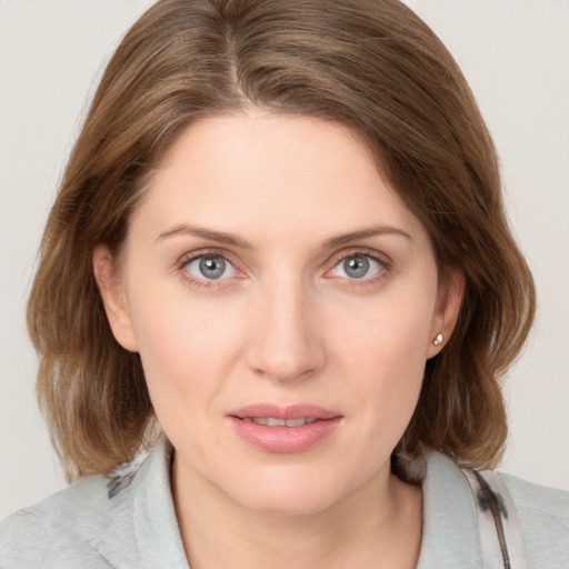 Joyful white young-adult female with medium  brown hair and blue eyes