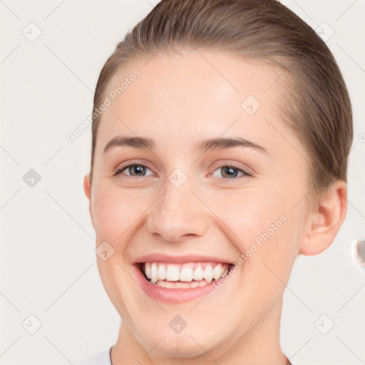 Joyful white young-adult female with short  brown hair and brown eyes