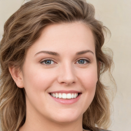 Joyful white young-adult female with medium  brown hair and green eyes