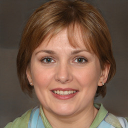 Joyful white adult female with medium  brown hair and blue eyes