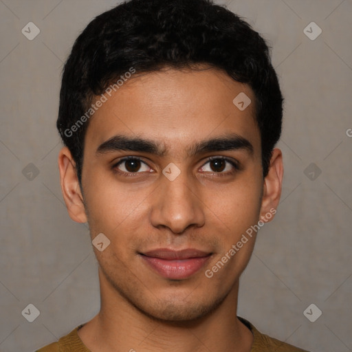 Joyful latino young-adult male with short  brown hair and brown eyes