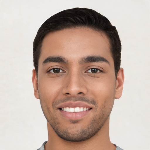 Joyful white young-adult male with short  black hair and brown eyes