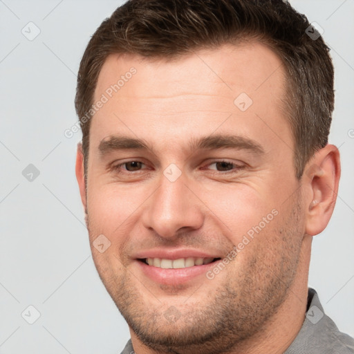 Joyful white young-adult male with short  brown hair and brown eyes