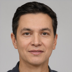Joyful white adult male with short  black hair and brown eyes