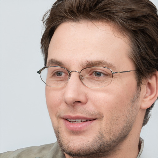 Joyful white adult male with short  brown hair and grey eyes