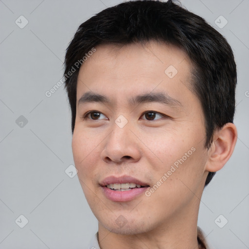 Joyful white young-adult male with short  black hair and brown eyes