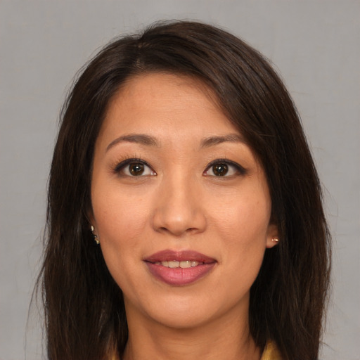 Joyful asian young-adult female with long  brown hair and brown eyes