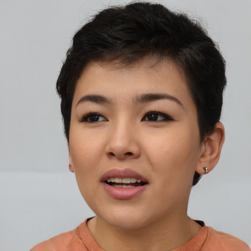 Joyful asian young-adult female with short  brown hair and brown eyes