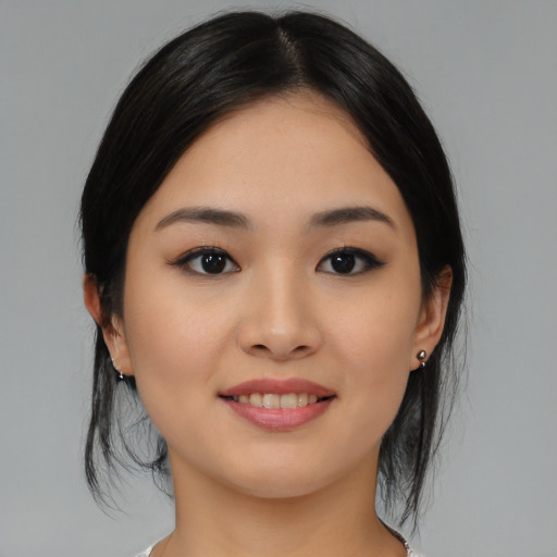 Joyful asian young-adult female with medium  black hair and brown eyes