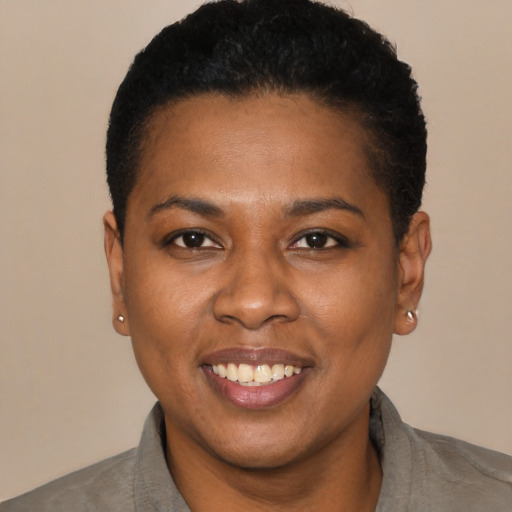 Joyful latino young-adult female with short  black hair and brown eyes