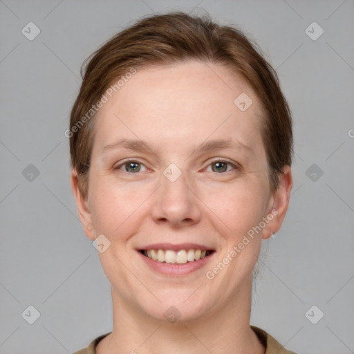 Joyful white adult female with short  brown hair and grey eyes