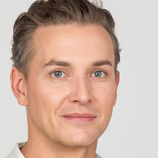 Joyful white adult male with short  brown hair and grey eyes