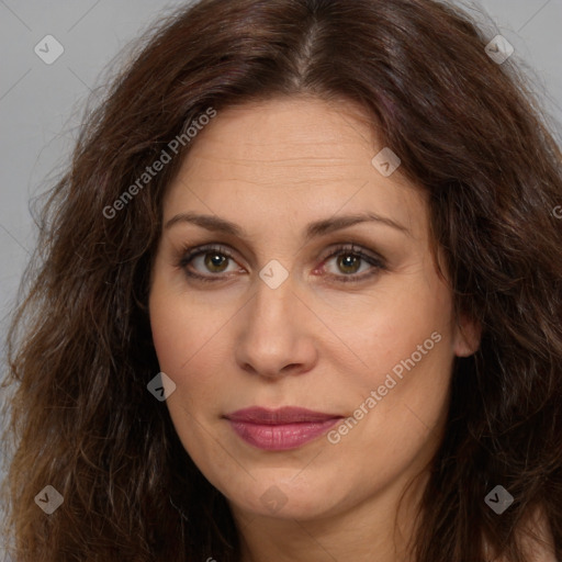 Joyful white adult female with long  brown hair and brown eyes