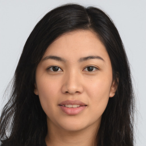 Joyful latino young-adult female with long  brown hair and brown eyes