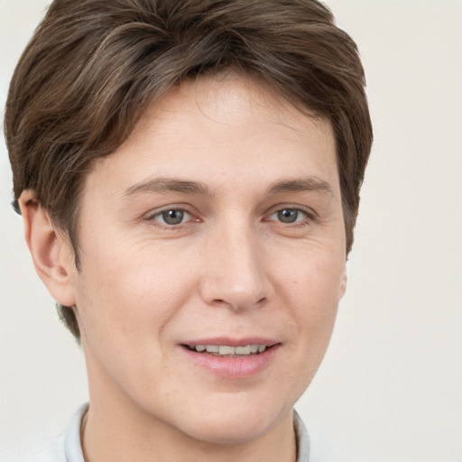 Joyful white young-adult female with short  brown hair and grey eyes