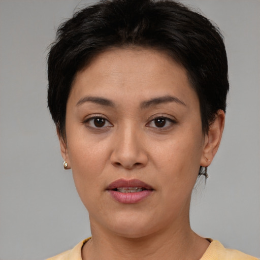 Joyful white adult female with short  brown hair and brown eyes