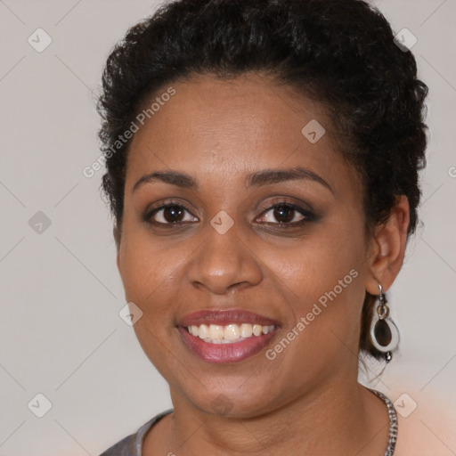 Joyful black young-adult female with short  brown hair and brown eyes